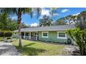 Charming single-story home with fresh green paint, landscaped yard, and welcoming porch at 530 Lake Bingham Rd, Lake Mary, FL 32746