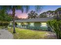Charming single-story home with fresh green paint, landscaped yard, and welcoming porch at 530 Lake Bingham Rd, Lake Mary, FL 32746