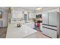 Bright kitchen with white cabinetry, modern appliances and quartz countertops at 5436 Tangerine Ave, Winter Park, FL 32792