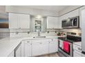 Updated kitchen featuring white cabinetry, stainless steel appliances and subway tile backsplash at 5436 Tangerine Ave, Winter Park, FL 32792