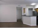 Open-concept living area featuring new flooring and neutral paint, flowing into the kitchen at 6021 Westgate Dr # 813, Orlando, FL 32835