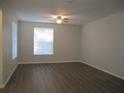 Bright and airy living room with new flooring, a ceiling fan, and a large window at 6021 Westgate Dr # 813, Orlando, FL 32835