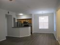 Open layout showcases an inviting living space and breakfast bar leading into the adjacent kitchen at 6021 Westgate Dr # 813, Orlando, FL 32835