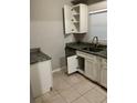 Functional kitchen space features essential appliances and ample cabinet storage at 6113 Hialeah St, Orlando, FL 32808