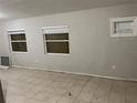 Inviting living room featuring tile floors, bright natural light, and neutral walls at 6113 Hialeah St, Orlando, FL 32808