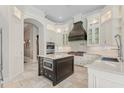 Gourmet kitchen featuring custom white cabinetry, a large center island, and professional-grade appliances at 6233 Rydal Ct, Windermere, FL 34786