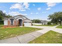 Charming single-Gathering home featuring a well-maintained lawn and attached two-car garage at 7243 Minippi Dr, Orlando, FL 32818