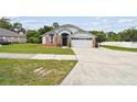 Charming single-Gathering home featuring a well-maintained lawn and attached two-car garage at 7243 Minippi Dr, Orlando, FL 32818