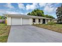 Wide driveway to a charming single-story home featuring a well-manicured lawn at 822 Glen Arden Way, Altamonte Springs, FL 32701