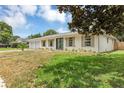 Attractive home featuring a lush front lawn, fresh exterior paint, shuttered windows, and double door entryway at 822 Glen Arden Way, Altamonte Springs, FL 32701