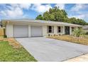 Single story home featuring an attached two car garage and front yard with a concrete driveway at 822 Glen Arden Way, Altamonte Springs, FL 32701