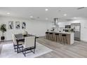 Bright open kitchen with island, stainless appliances, a modern range hood, and lots of cabinets at 822 Glen Arden Way, Altamonte Springs, FL 32701