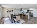 Beautiful dining area and open kitchen with stainless steel appliances, island seating, and stylish decor at 822 Glen Arden Way, Altamonte Springs, FL 32701