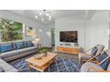 Comfortable living room with a large window, modern decor, and inviting seating at 8812 Oakwood Dr, Lake Wales, FL 33898