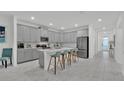Bright kitchen featuring gray cabinets, stainless steel appliances, a center island and modern countertops at 9239 Sommerset Hills Dr, Davenport, FL 33896