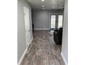 Inviting living room with hardwood floors, neutral walls, and sliding glass doors to the outside at 9471 Comeau St, Gotha, FL 34734