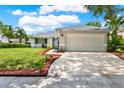 Well-maintained home featuring a spacious driveway and colorful landscaping at 963 Beach Breeze Dr, Orlando, FL 32835