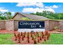 A Cinnamon Bay sign situated within a brick wall and surrounded by well-maintained landscaping at 963 Beach Breeze Dr, Orlando, FL 32835