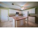 Bright kitchen featuring white cabinets, an island with a sink, and modern appliances at 964 Clayton Dr, Deltona, FL 32725