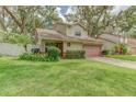 Beautiful home with a two-car garage, tidy landscaping, and a well-kept lawn enhancing curb appeal at 9948 Timber Oaks Ct # 14, Orlando, FL 32817