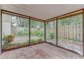 Covered patio with tile flooring, screened walls, and a view of the private backyard area at 9948 Timber Oaks Ct # 14, Orlando, FL 32817