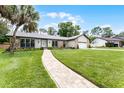 Well-maintained home with a lovely front yard, stone accents, and a charming walkway leading to the front door at 107 Laurel Oak Dr, Longwood, FL 32779