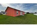 Spacious backyard showcasing lush green grass and ample room for outdoor activities and relaxation at 113 Kaigen Ct, Haines City, FL 33844