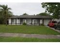 Traditional home with a garage and a green front lawn at 11418 Ashboro Dr, Orlando, FL 32837