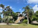 Eye-catching house with unique design, surrounded by mature landscaping and trees at 1292 Nadine Dr, Deltona, FL 32738