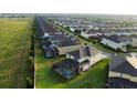 Aerial view of backyards with screened-in pools in a neighborhood with neat landscaping at 1544 Nassau Point Trl, Kissimmee, FL 34747