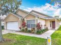Beautiful single-story home with a well-maintained lawn, walkway, and inviting front entrance at 2314 Cormorant St, Kissimmee, FL 34743