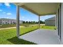 View from the back porch looks out over the lawn towards a pond and houses at 2372 Orchid Dr, Davenport, FL 33837