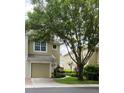 Charming townhome with a one-car garage, complemented by mature trees and lush landscaping at 2548 Galliano Cir, Winter Park, FL 32792