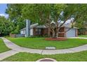 Charming home with brick accents, mature landscaping, and well-maintained lawn, in a peaceful setting at 3107 Ash Park Loop, Winter Park, FL 32792