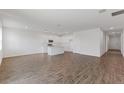 Open-concept living room and kitchen area with white walls and tile flooring at 3144 Suraj Cir, Tavares, FL 32778