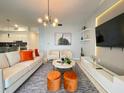 Open living room has modern lighting, sleek furniture, a TV, and stylish decor at 3191 Paradox Cir # 102, Kissimmee, FL 34746