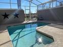 Indoor pool surrounded by an enclosed lanai with seating, offering a private and relaxing space at 456 Ocean Course Ave, Davenport, FL 33896