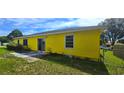 Side view of the home exterior, showcasing a sliding door and some landscaping at 4719 Miranda Cir, Orlando, FL 32818