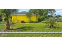 Fenced backyard, showing a bit of landscaping and a grassy area at 4719 Miranda Cir, Orlando, FL 32818