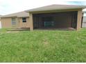 Spacious backyard featuring a screened-in lanai, providing a comfortable outdoor living space at 4852 Magnolia Preserve Dr, Winter Haven, FL 33880
