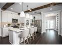 Beautiful kitchen with hardwood floors, island with seating, stainless steel appliances, and white cabinets at 5328 Teirgarten St, St Cloud, FL 34771