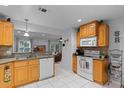 Well-lit kitchen featuring granite countertops and wooden cabinetry, open to the living area at 5815 England Ave, Orlando, FL 32808