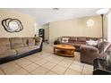 Spacious living room featuring tile floors, neutral walls, and modern furnishings at 5820 Indian Hill Rd, Orlando, FL 32808