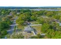 Expansive aerial view of the property showcasing its location, surrounded by lush greenery and neighborhood streets, and with lake in the background at 624 Cardinal St, Ocoee, FL 34761