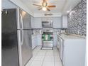 Well-lit kitchen with stainless steel appliances, gray cabinets, and attractive backsplash, offering a modern and functional space at 624 Cardinal St, Ocoee, FL 34761