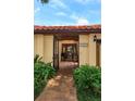 Inviting gated entrance leading to a cozy home with a brick path and lush greenery at 8143 Terragona Ct, Orlando, FL 32836