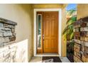 Close-up of a stylish front door with stone accents and sidelight window at 969 Springs Landing Dr, Deltona, FL 32725