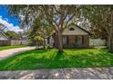 Attractive home with a brick facade, complemented by mature trees and a green lawn at 1000 Chesterfield Cir, Winter Springs, FL 32708