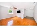 Bright living room featuring hardwood floors, a ceiling fan, and a large window at 1000 Chesterfield Cir, Winter Springs, FL 32708