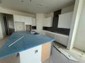 Modern kitchen with white cabinets, a large island, and stylish gray backsplash at 10224 Fiddley Aly, Orlando, FL 32827
